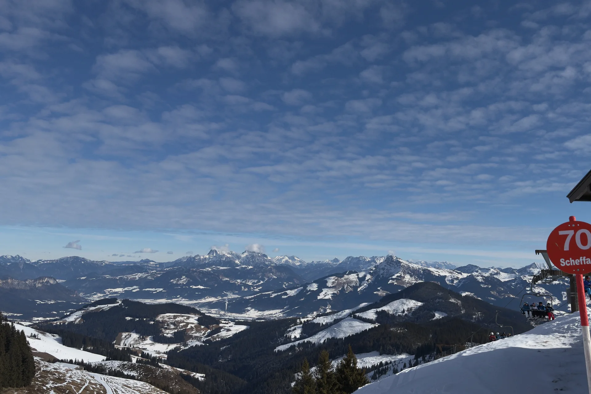 Mountain panorama and snowy pistes near Scheffau in SkiWelt, with the red marker for piste 70.